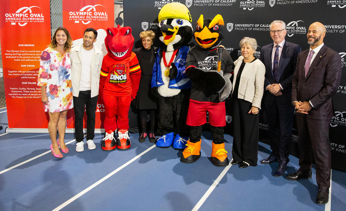 At the event, from left: MC Catriona Le May Doan, speedskating athlete Gilmore Junio, Rex, Mayor Jyoti Gondek, Ollie, Kumi, Provost Penny Werthner, President and Vice-Chancellor Ed McCauley, Chancellor Jon Cornish.