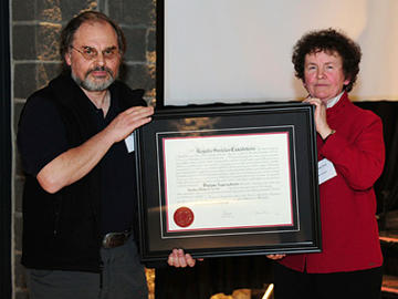 Royal Society of Canada president Yolande Grisé congratulates the University of Calgary’s Stephen Larter on his appointment as a society fellow. 